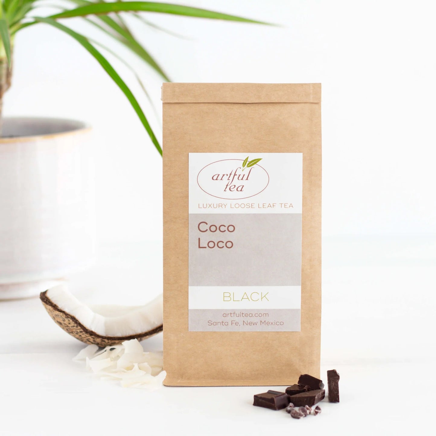 Coco Loco Black Tea shown packaged in a brown Kraft bag with coconut and chocolate pieces nearby.