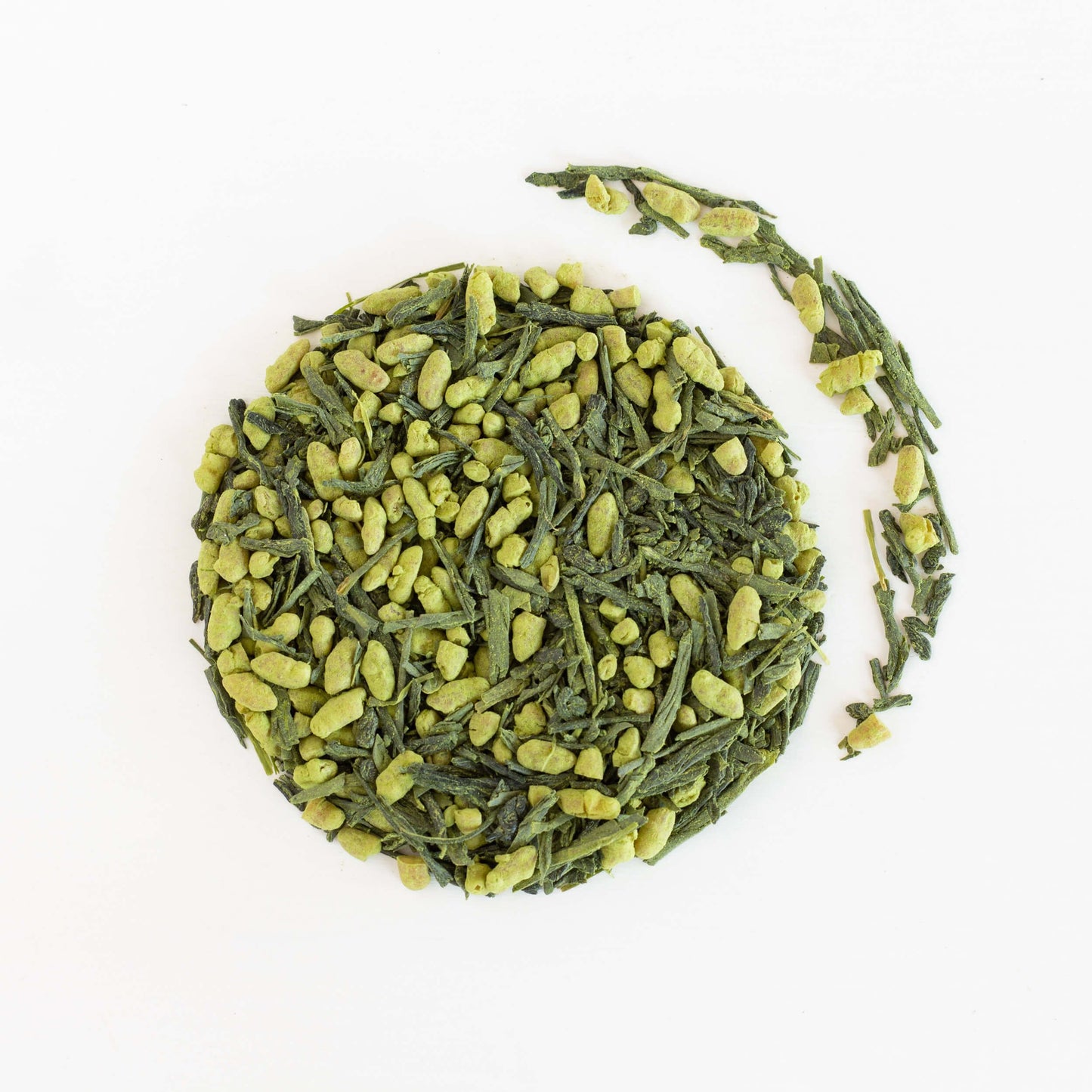 Genmaicha Matcha Green Tea shown from above as loose leaf tea in a circle with tea leaves to the right of it.