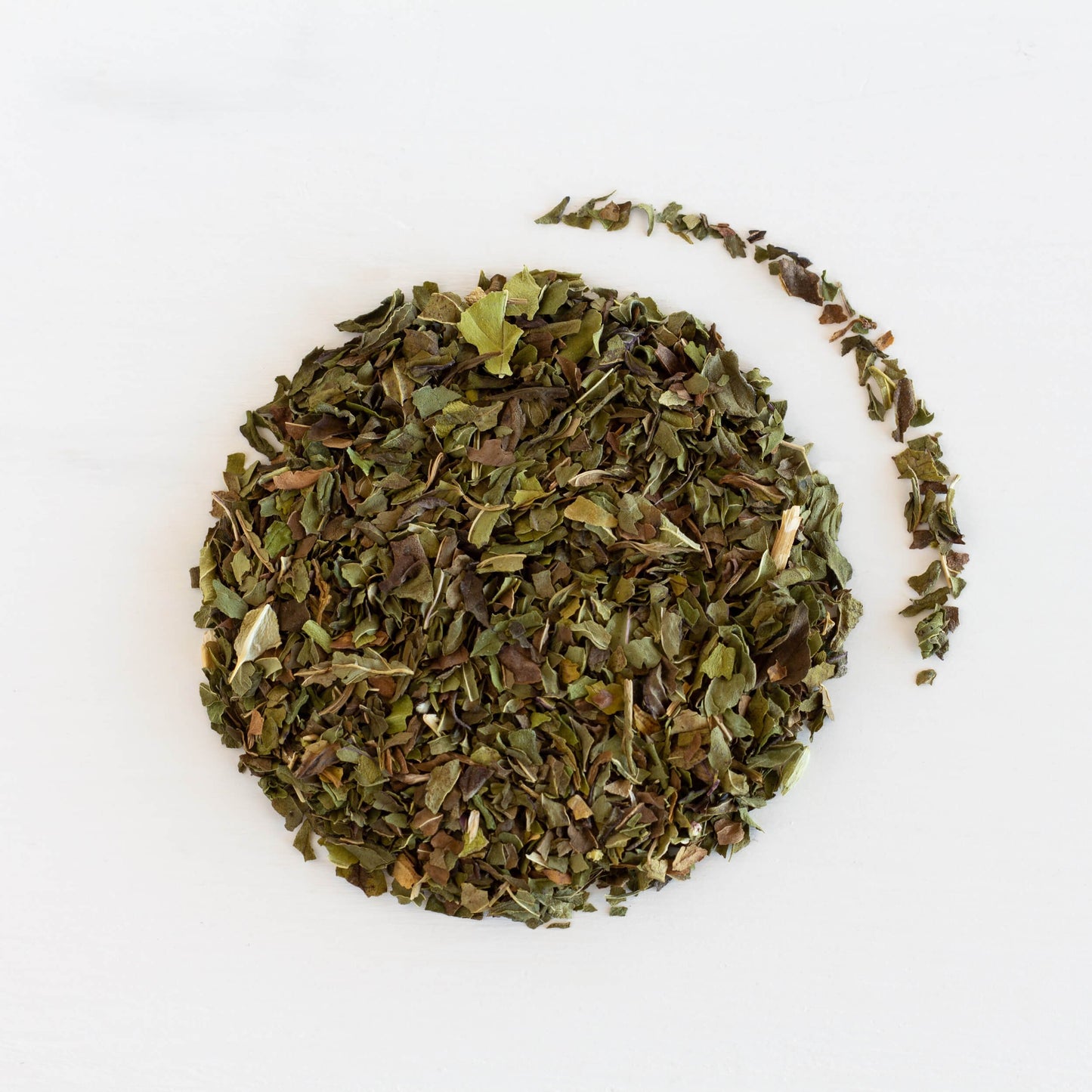Peppermint Herbal Tea shown as loose leaf tea from in a circle from above.