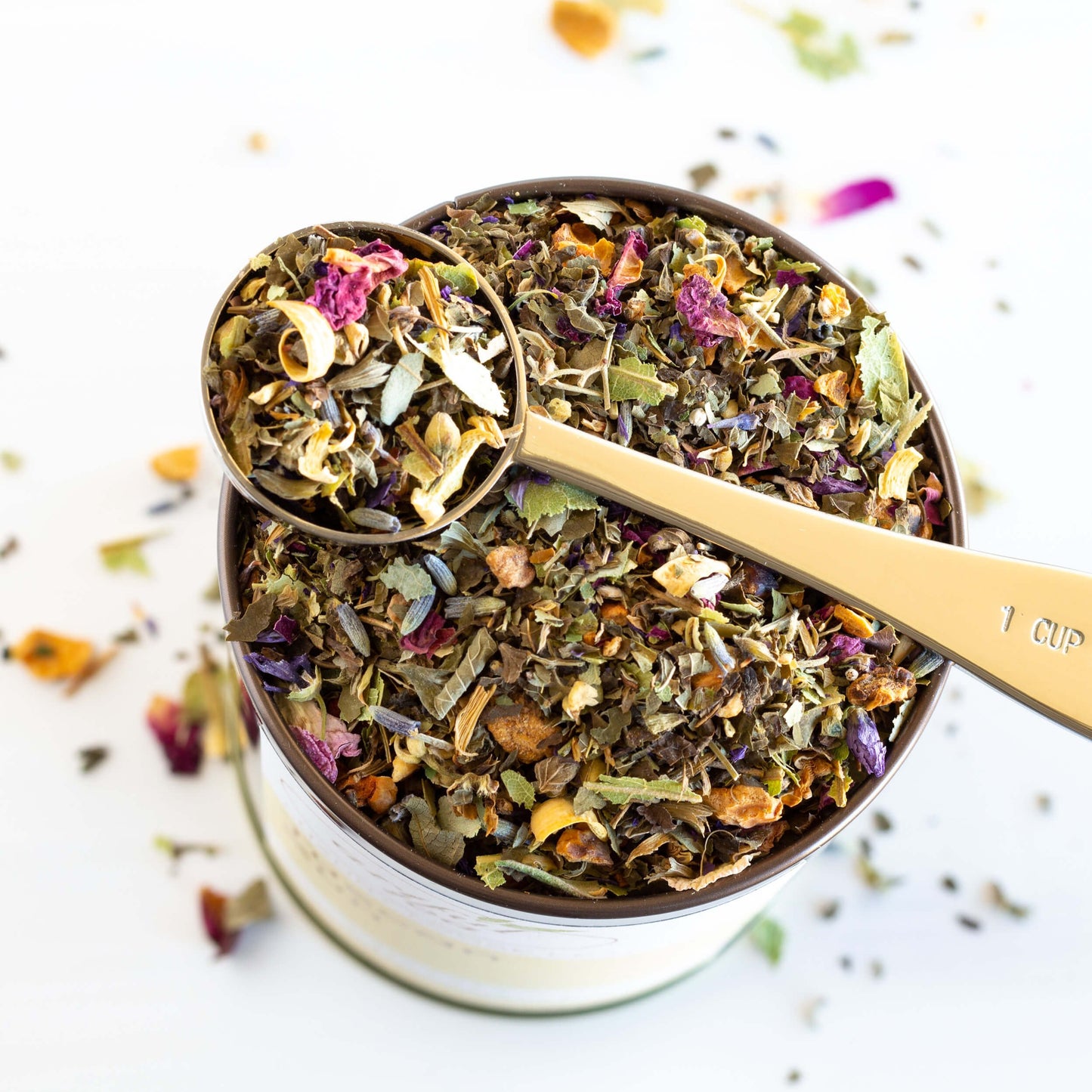 Tuscan Sun Herbal Tea shown from above packaged in a brown tin with the lid off.