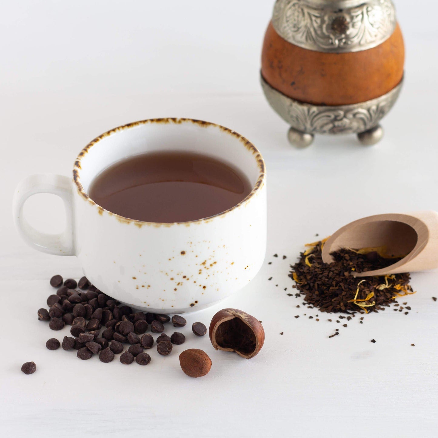 Enamel mug of Nutty Mocha Mate Tea with chocolate chips and gourd