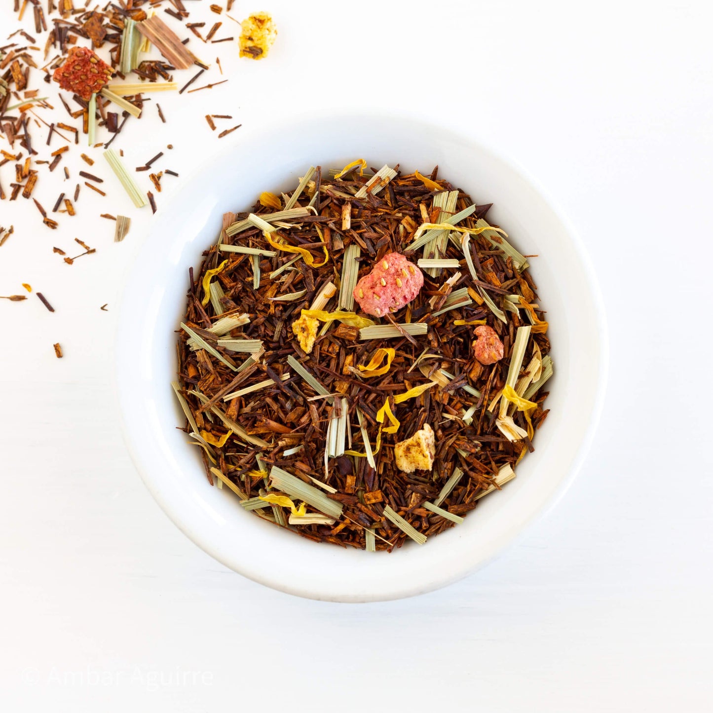 Strawberry Mango Rooibos Herbal Tea shown from above as loose leaf tea in a white bowl.