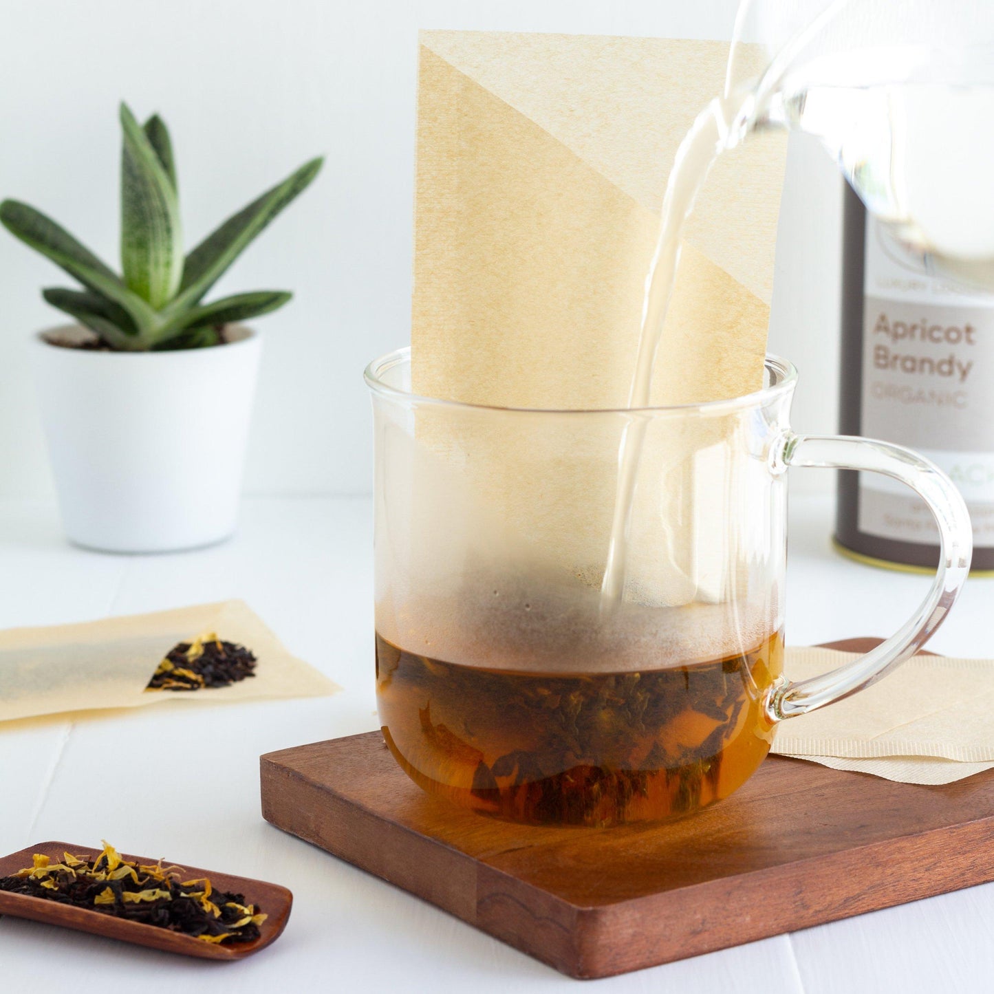 Tea Filter standing in glass mug while being filled with water