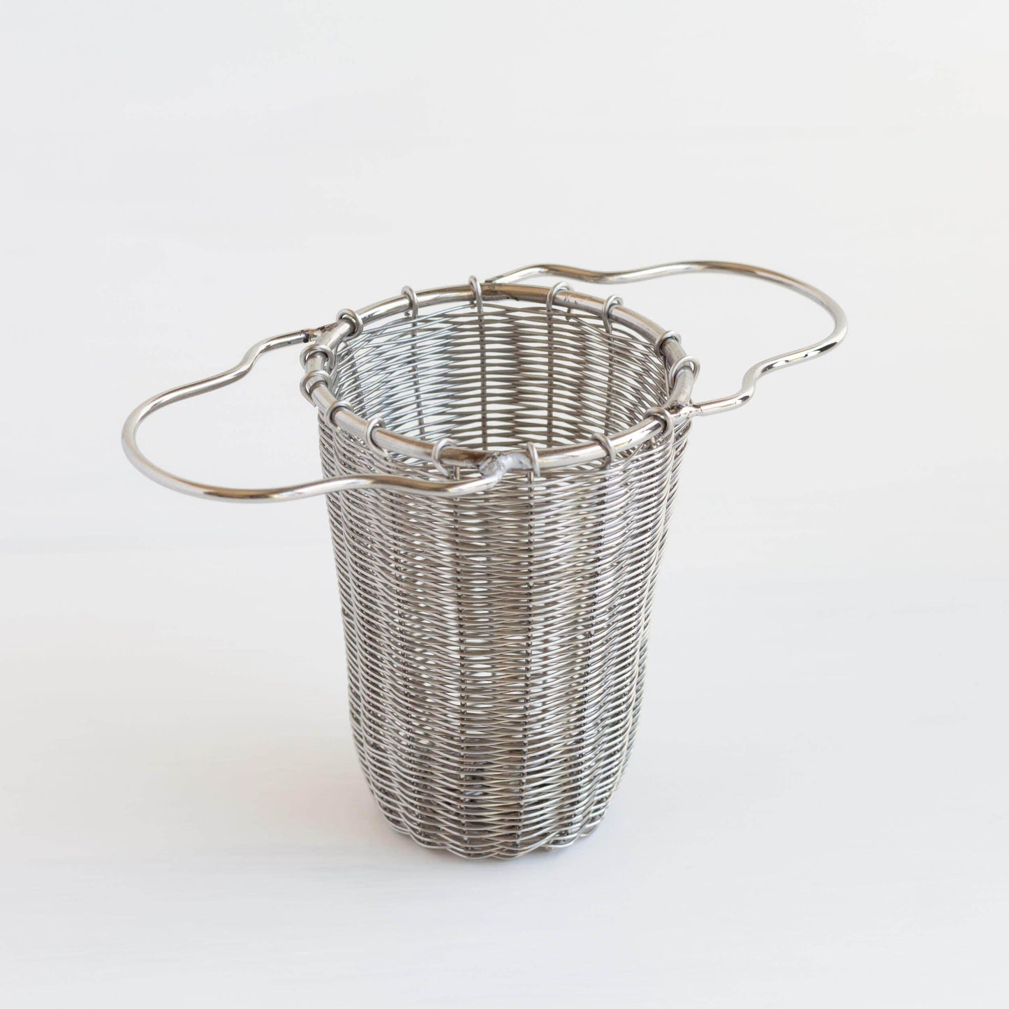 Metal tea strainer standing up