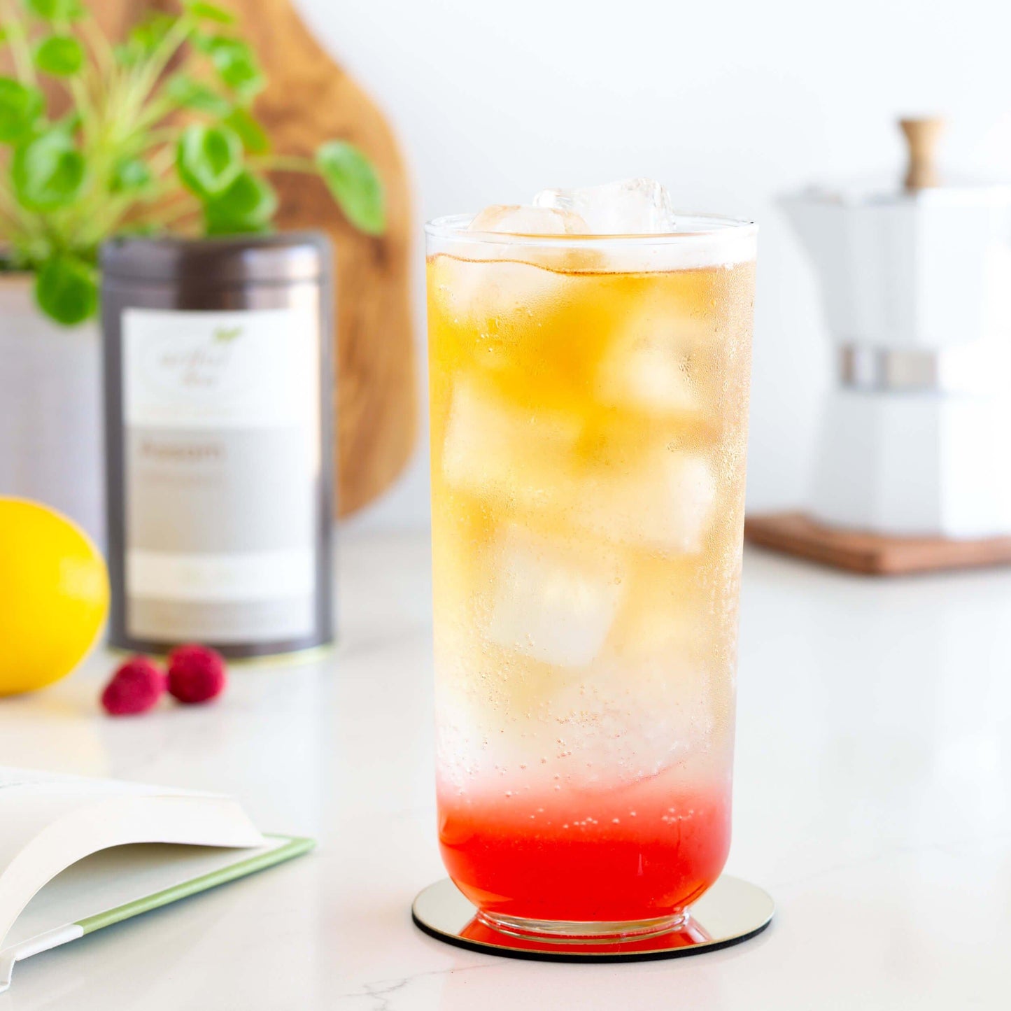 Sparkling Assam Tea with Raspberry Lemon Syrup shown in a glass with ice