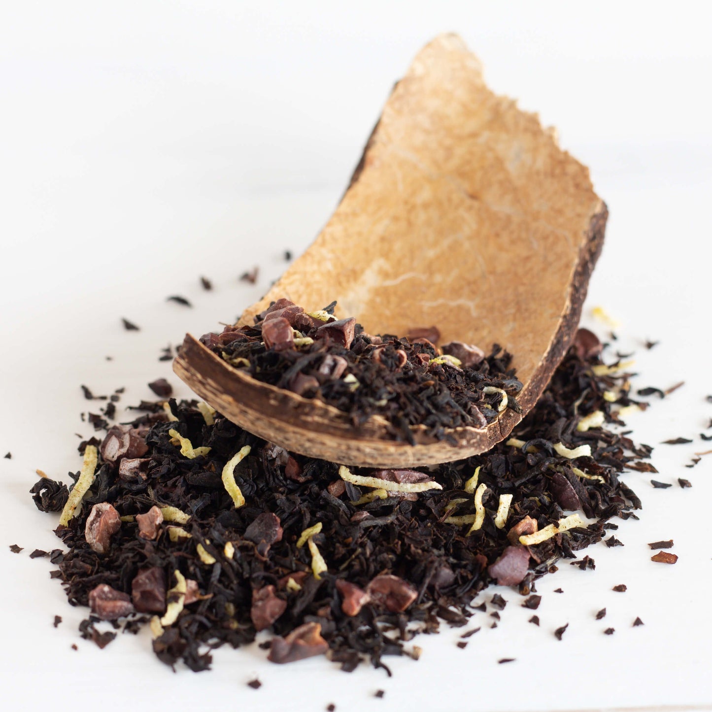 Coco Loco Organic Black Tea shown as loose tea leaves spilling out of a coconut shell
