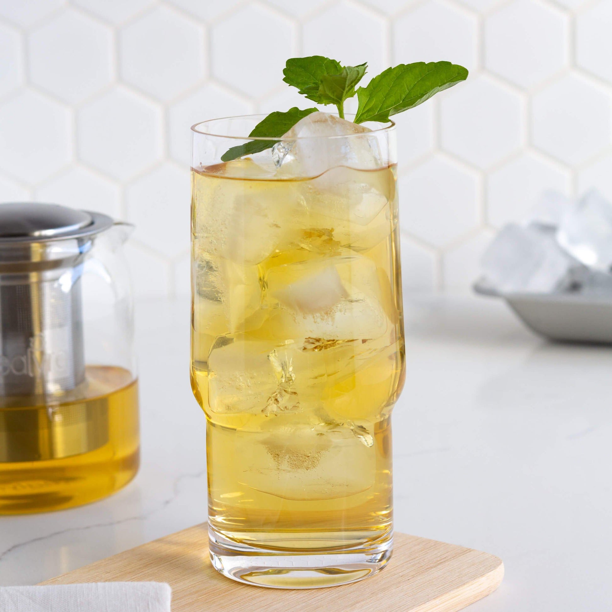 Moroccan Mint Green Tea shown iced in a glass with mint sprig