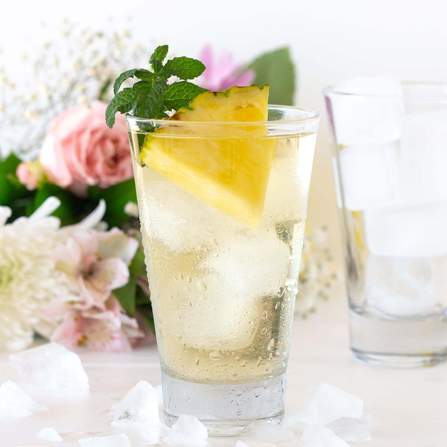 Spring Fancy Green and White Tea shown as iced tea with pineapple wedge