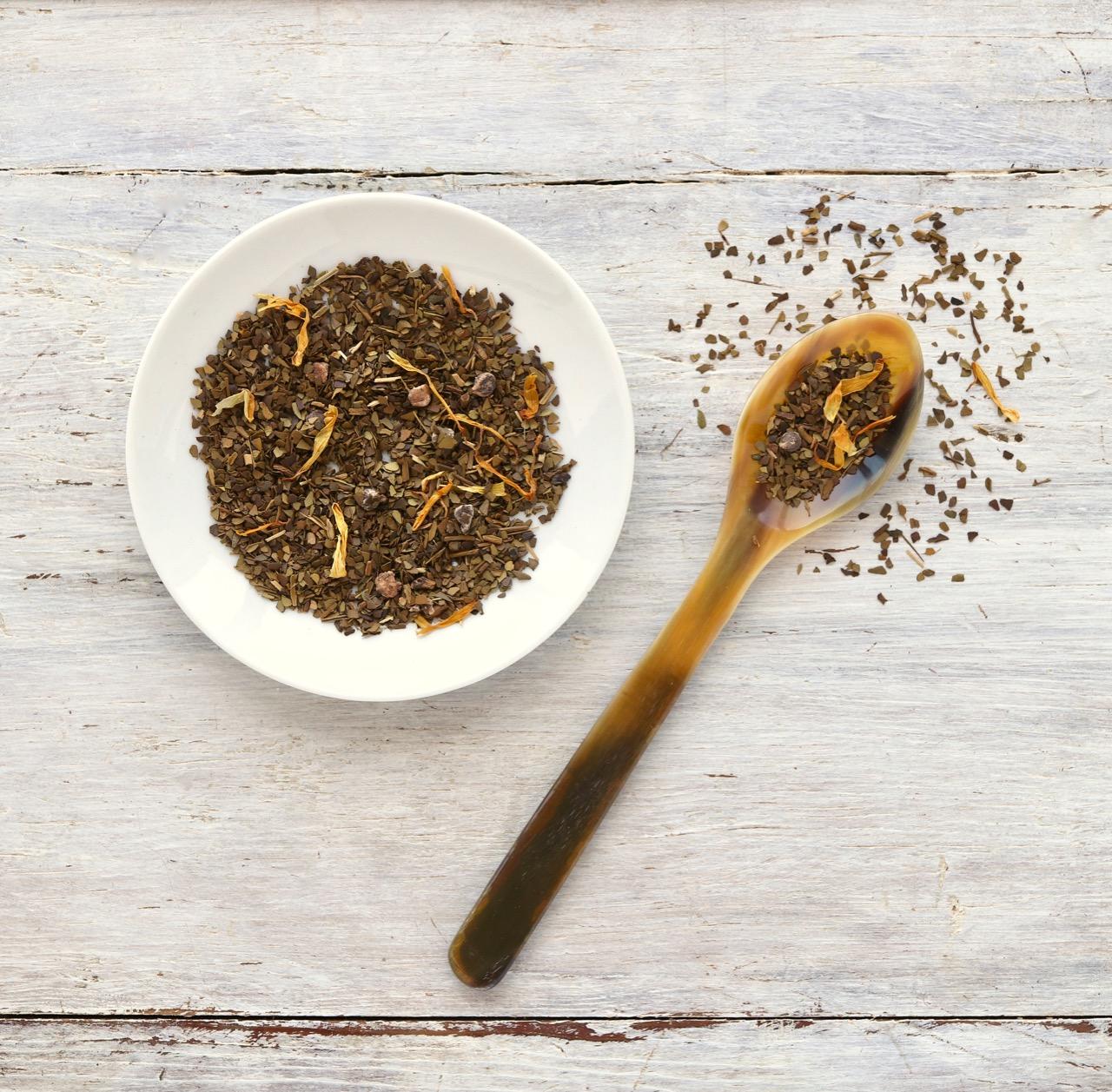 White bowl of loose-leaf Nutty Mocha Mate with wooden spoon