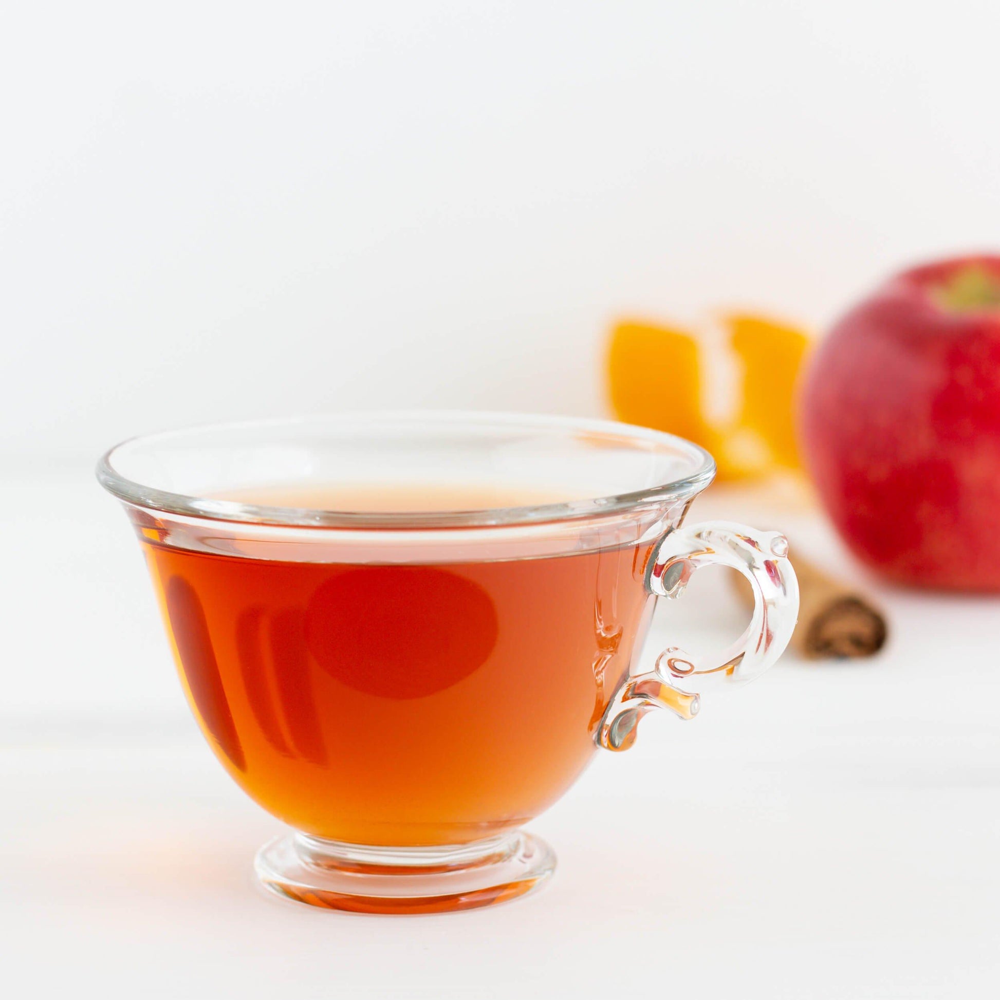 Glass cup of Honeybush Hot Cider Herbal Tea with apple