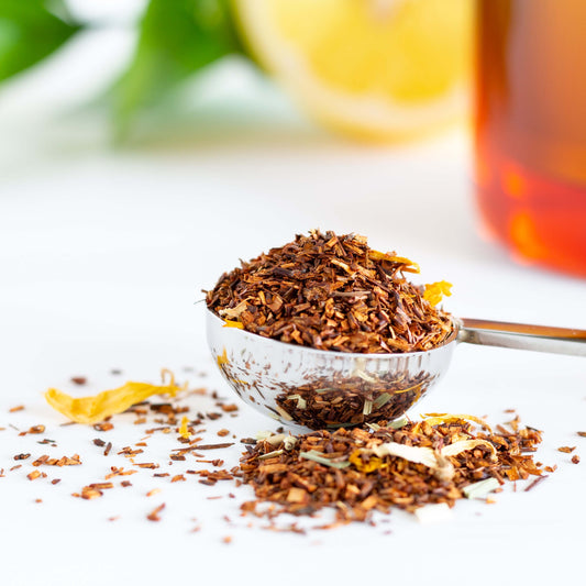 Lemon Cream Rooibos Herbal Tea shown as loose leaf tea in a silver teaspoon.
