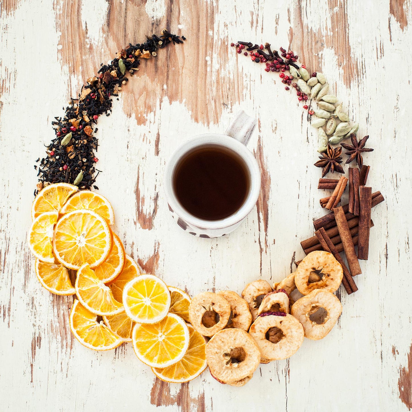 Solstice Spice Black Tea ingredients in a circle around a mug