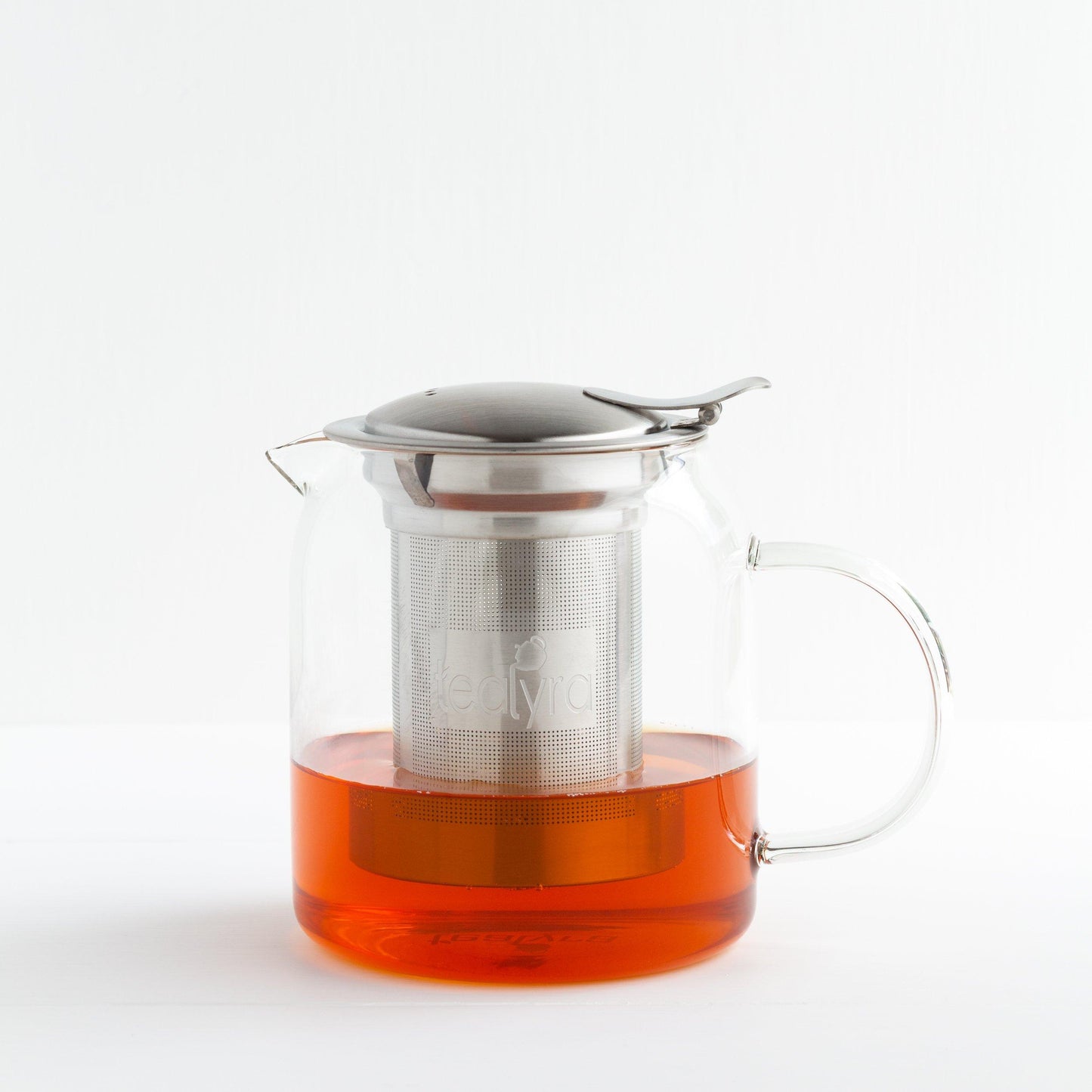 Glass Teapot with Stainless Steel Infuser, shown approximately one-third full with brewed tea.