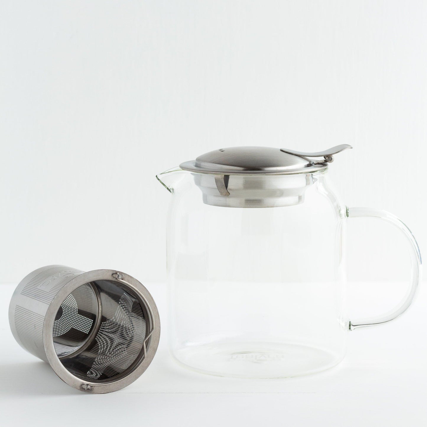 Glass Teapot with Stainless Steel Infuser shown with the infuser lying on its side outside of the teapot