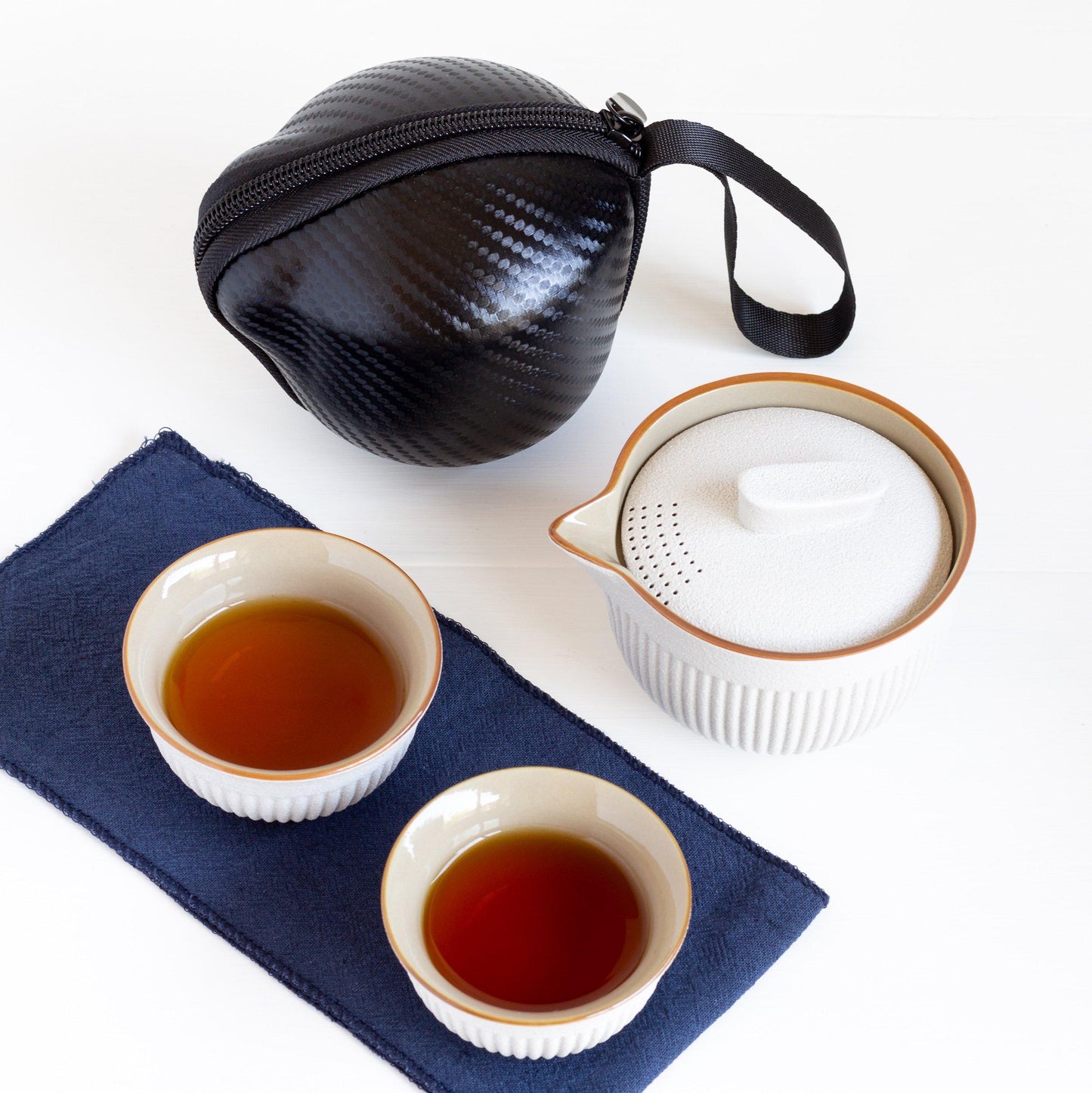 Tea travel set with brewed tea in two cups